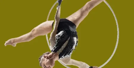Aerial hoop performer executing an elegant inverted pose, showcasing strength and flexibility for luxury event entertainment
