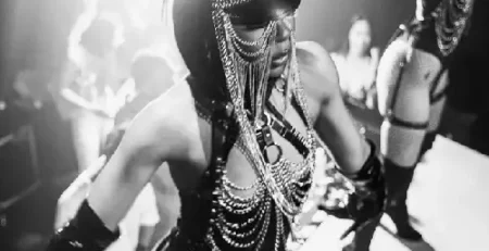 Gogo dancer performing in an immersive nightclub-style event with dramatic costume styling and energetic stage atmosphere in Toronto.