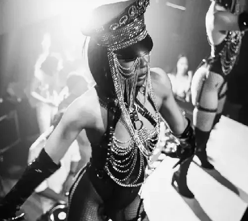 Gogo dancer performing in an immersive nightclub-style event with dramatic costume styling and energetic stage atmosphere in Toronto.