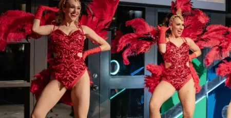 Professional showgirls performing in vibrant red feather costumes at a luxury corporate and private event in Toronto.